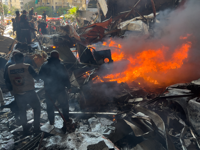 Rescuers gather at the site of an Israeli airstrike in central Beirut, Lebanon, Wednesday,