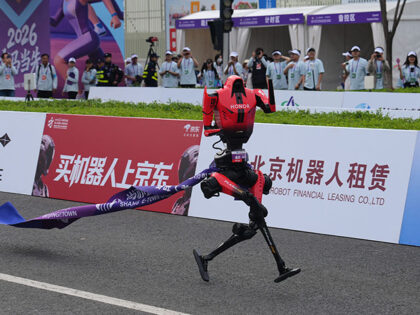 Title: China Robot Marathon Image ID: 26109189609185 Article: A robot tagged along a ribbo