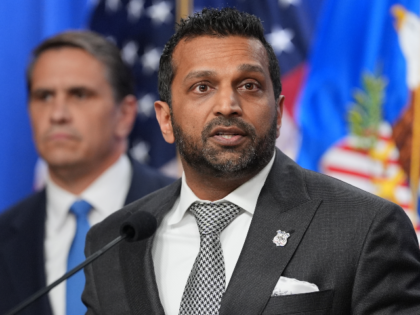 Acting Attorney General Todd Blanche listens as FBI Director Kash Patel speaks during a ne