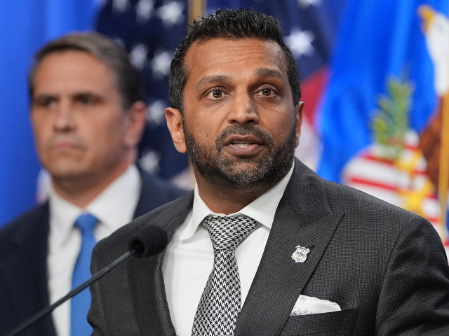 Acting Attorney General Todd Blanche listens as FBI Director Kash Patel speaks during a ne