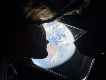 Astronaut looking back at Earth