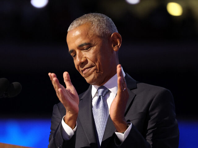 Former US President Barack Obama applauds as he speaks on the second day of the Democratic