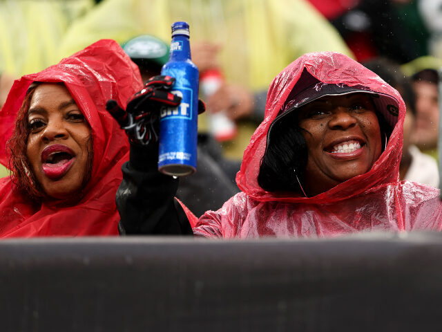 An Atlanta Falcons fan holds a Bud Light bottle during an NFL football game between the Ne