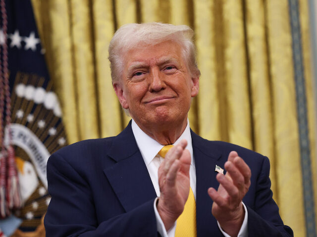 U.S. President Donald Trump applauds after Howard Lutnick was sworn in as U.S. Commerce Se