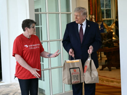 US President Donald Trump speaks with a Doordash delivery worker after she delivered McDon