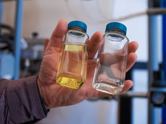 GettyImages-1634219108 A worker holds containers of brine, left, and lithium after the two have been separated at