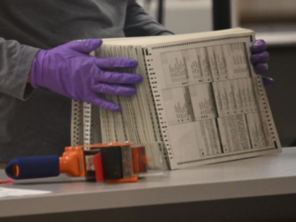 An election worker counts ballots inside the Maricopa County Tabulation and Election Cente