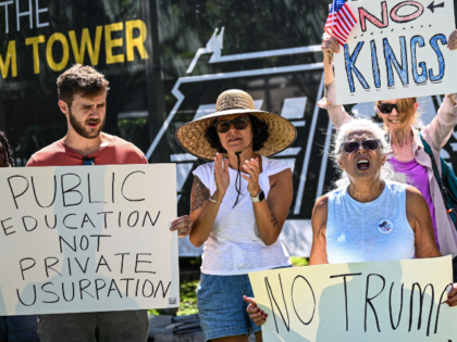 Protesters hold placards and chant slogans during a demonstration against plans to build t