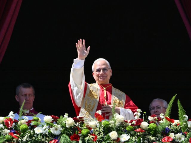 Pope Leo XIV waves to the crowd from the main balcony of St. Peter's basilica for the