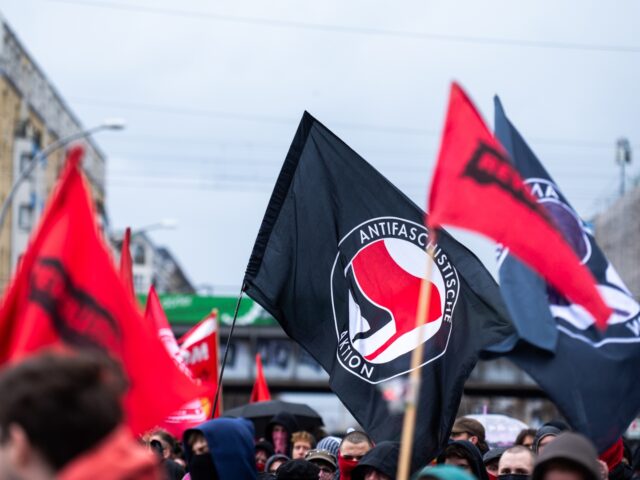 05 April 2026, Berlin: Protesters wave antifa flags at a demonstration called after two 19