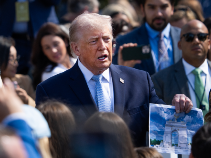 UNITED STATES - APRIL 6: President Donald Trump holds a picture of the proposed Triumphal