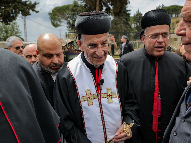 TOPSHOT - Cardinal Bechara al-Rai (C), Maronite Patriarch of Antioch, visits the predomina