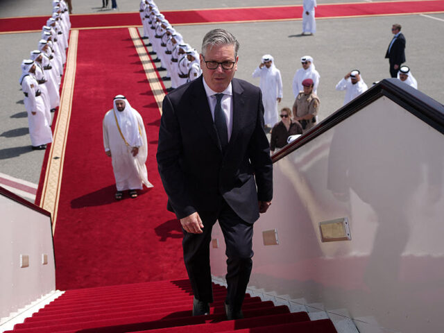 Britain's Prime Minister Keir Starmer boards his plane at the airport in Doha, Qatar