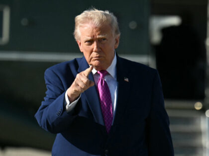 US President Donald Trump gestures after stepping off Marine One at Joint Base Andrews, Ma