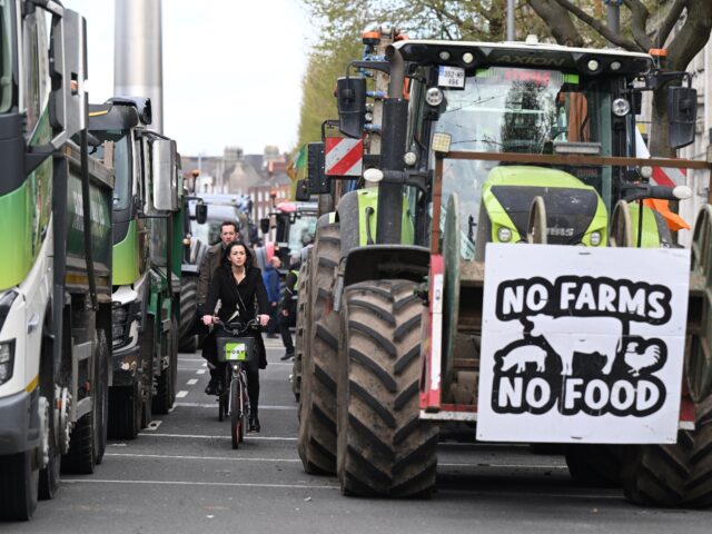 DUBLIN, IRELAND - APRIL 11: Members of the public make their way past trucks and tractors