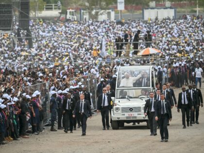 TOPSHOT - CORRECTION / Pope Leo XIV (C) waves from the Popemobile to the crowd as he arriv