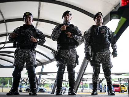 Police officers guard Tocumen International Airport ahead of the extradition from Venezuel