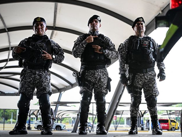 Police officers guard Tocumen International Airport ahead of the extradition from Venezuel