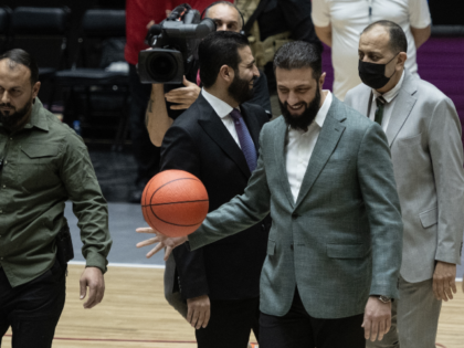 DAMASCUS, SYRIA - APRIL 20: Syrian President Ahmed al-Sharaa plays with a basketball befor