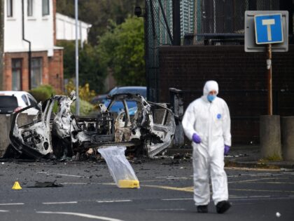 DUNMURRY, NORTHERN IRELAND - APRIL 26: Forensic officers gather evidence at the scene of a