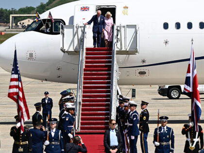 Britain's King Charles III and Britain's Queen Camilla step off their plane upon