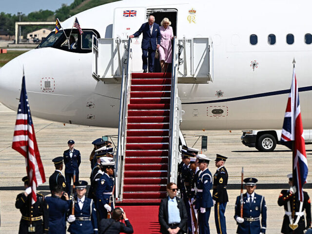 Britain's King Charles III and Britain's Queen Camilla step off their plane upon