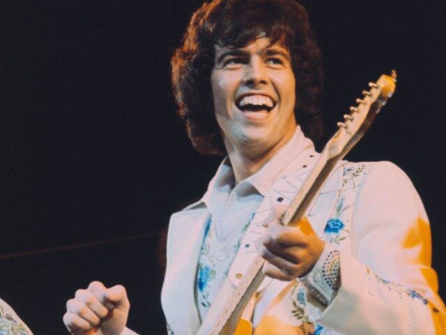 Musician and guitarist Alan Osmond performs live on stage with American family pop group T