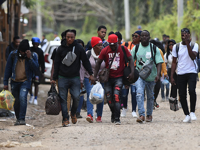 Cuban and Haitian migrants en route to the United States leave the Migrant Care Center aft