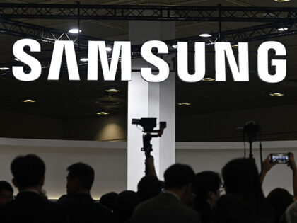Visitors walk past the logo of Samsung Electronics during the 2026 World IT Show in Seoul