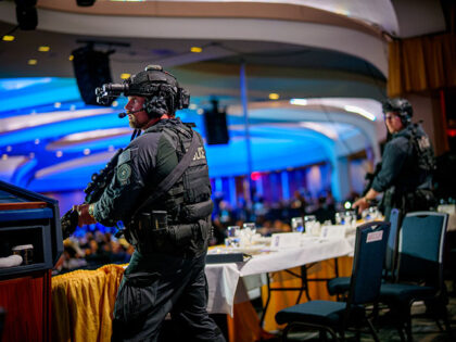 Armed Secret Service agents stand on stage during a shooting incident at the annual White