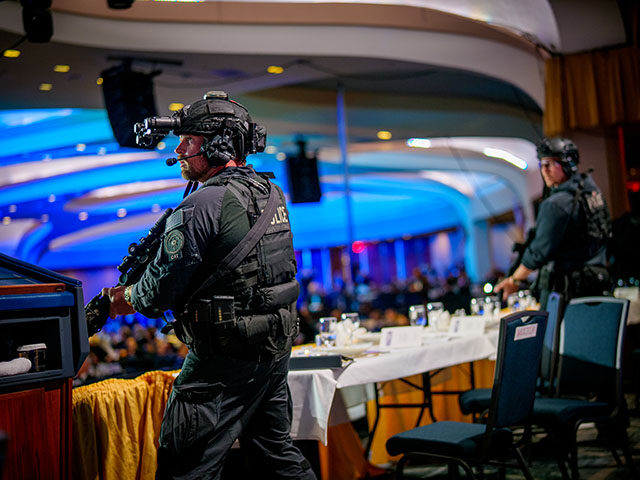 Armed Secret Service agents stand on stage during a shooting incident at the annual White