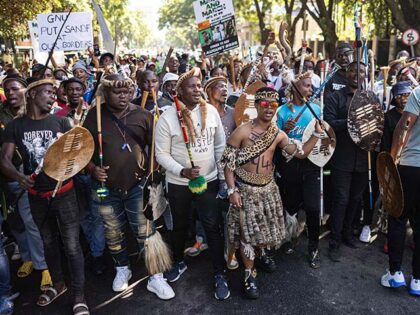 Protesters chant slogans and gesture during a protest march against undocumented migrants