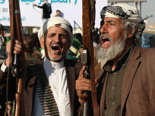 Houthi supporters shout slogans as they celebrate independence day, marking the end of Bri