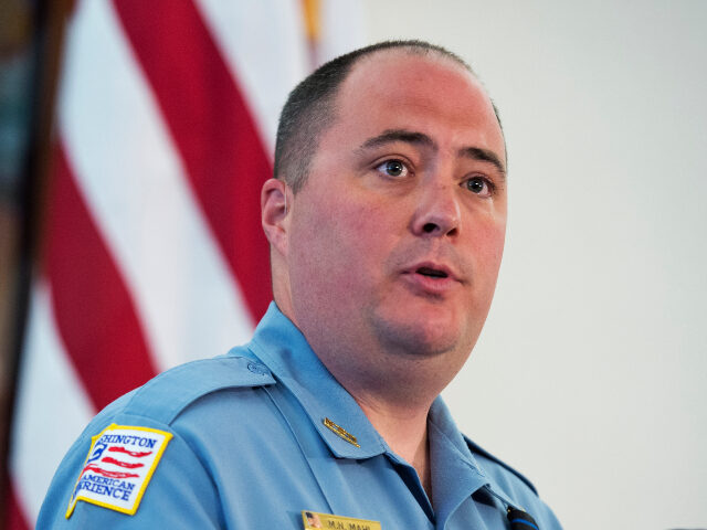 Sgt. Matthew Mahl, and D.C. Police Chief Cathy Lanier, attend a memorial service near poli