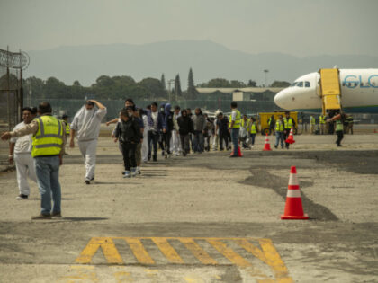 A charter flight carrying 104 departed Guatemalans arrives from Alexandria, Louisiana, at