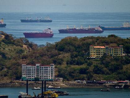 Cargo ships wait to go through the Panama Canal in Panama City on April 21, 2026. Accordin