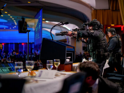 WASHINGTON, DC - APRIL 25: Armed Secret Service agents stand on stage during a shooting in