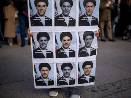 MADRID, SPAIN - 2026/03/07: A protester holds a placard with the face of Pedro Sánchez, P