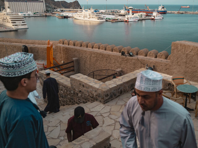 Oil tankers and high speed crafts sit anchored at Muscat Anchorage near the Strait of Horm