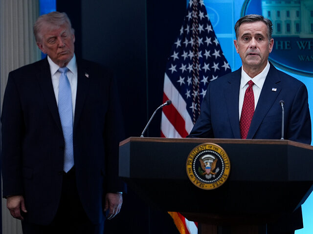 President Donald Trump watches as CIA Director John Ratcliffe speaks with reporters in the