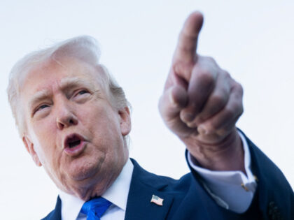US President Donald Trump speaks to reporters before boarding Air Force One at Palm Beach