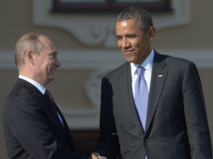 In this handout image provided by Host Photo Agency, Russian President Vladimir Putin (L)