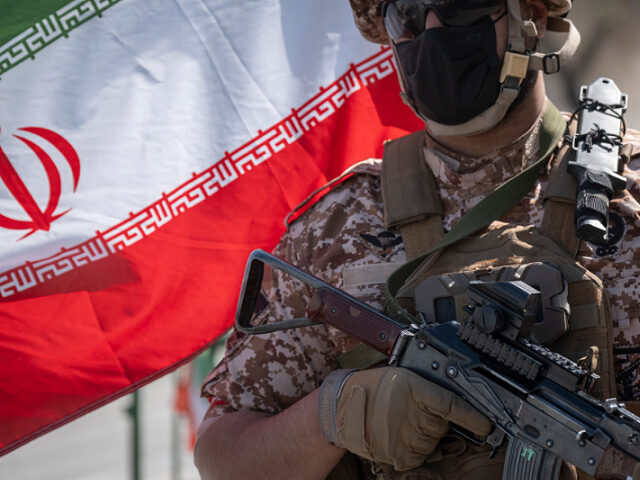 An armed military member of the Islamic Revolutionary Guard Corps (IRGC) holds an AK-45 ri
