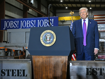 President Donald Trump is greeted by attendees at his speech about the economy at the Coos