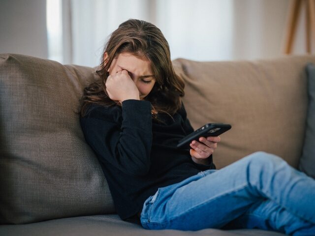 girl crying over deepfake AI porn