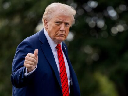 US President Donald Trump walks on the South Lawn of the White House after arriving on Mar