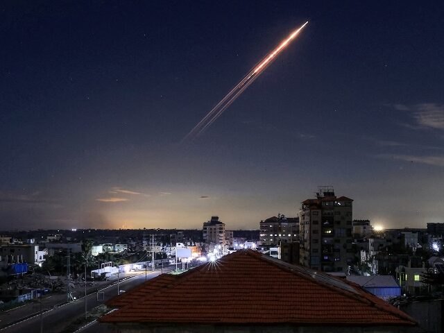 TOPSHOT - A missile launched from Iran is pictured in the sky from the Bureij camp for Pal