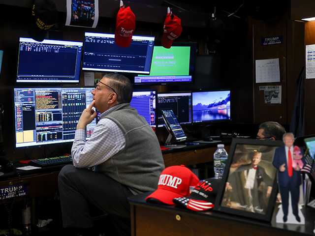"Trump" hats hang near traders on the floor of the New York Stock Exchange on Ma