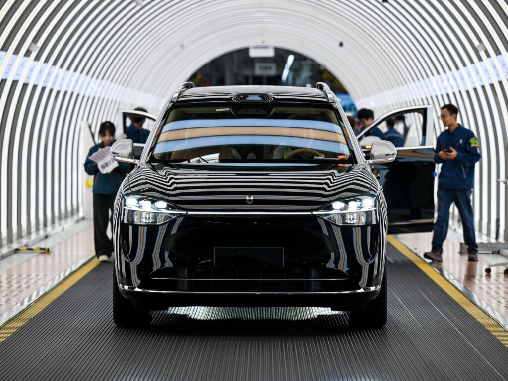 CHONGQING, CHINA - APRIL 02: Employees check new energy vehicles before they roll off the production line at Seres Super Factory on April 2, 2026 in Chongqing, China. (Photo by Wang Jiaxi/VCG via Getty Images)