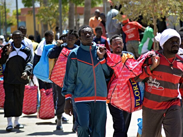 Would-be immigrants walk in the Centre for Temporary Stay of Immigrants (CETI), following